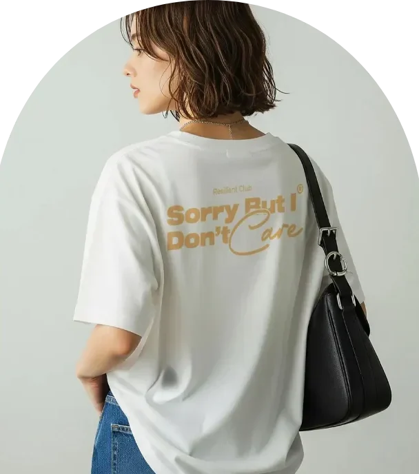 Back view of a woman wearing a white graphic T-shirt with the phrase “Sorry But I Don’t Care” in bold lettering.